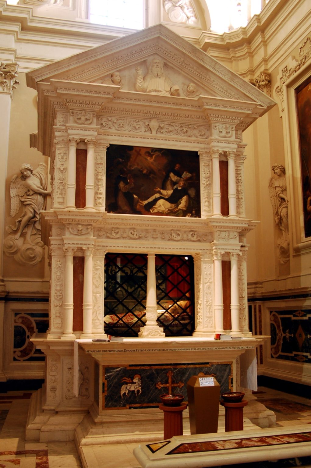 The tomb of Pope St. Celestine V in the basilica of Santa Maria di Collemaggio, adorned with intricate carvings and artwork.